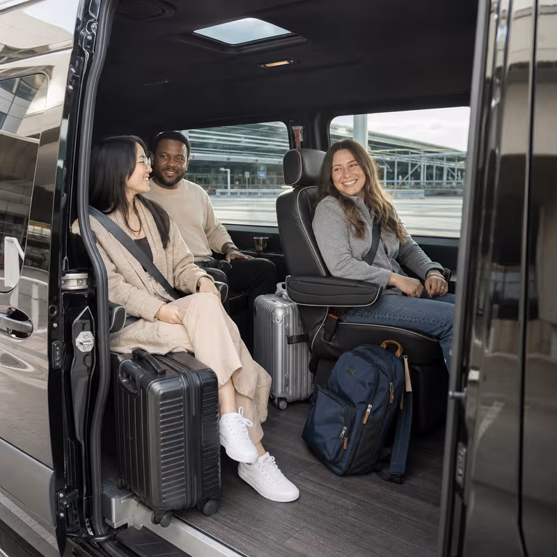 Passengers loading luggage while boarding an Phoenix group shuttle