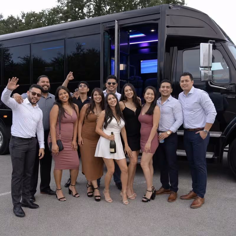 Group boarding a white charter bus for Birthday Transportation transportation in Phoenix