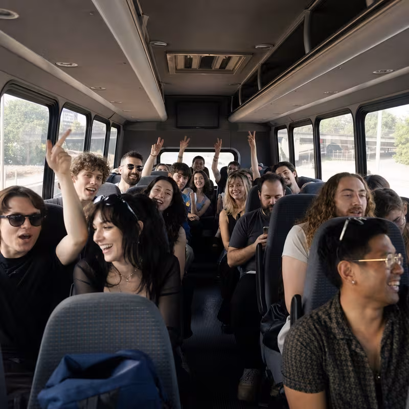 Party bus interior with wraparound leather seating and LED lighting in Phoenix