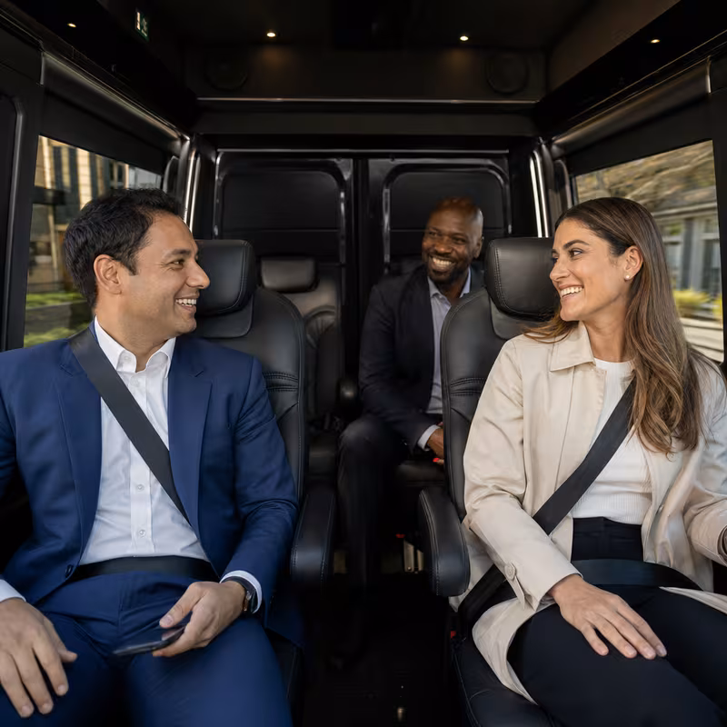 Group boarding a white charter bus for Corporate Transportation transportation in Phoenix