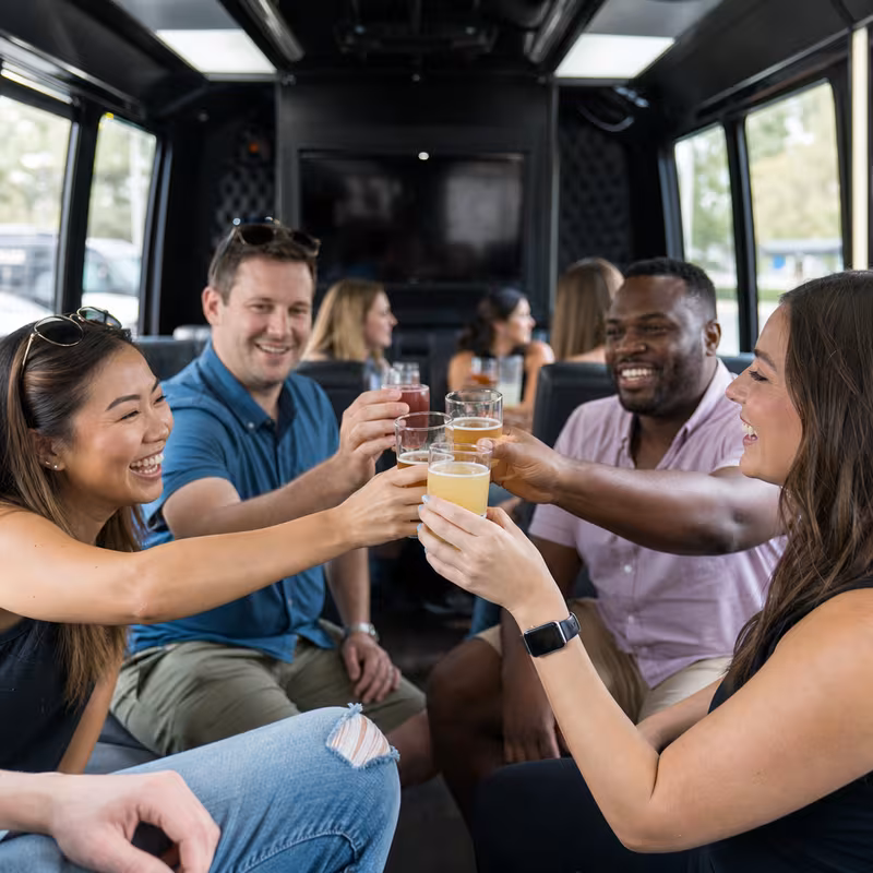 Group boarding a white charter bus for Winery & Brewery Tour Transportation transportation in Phoenix